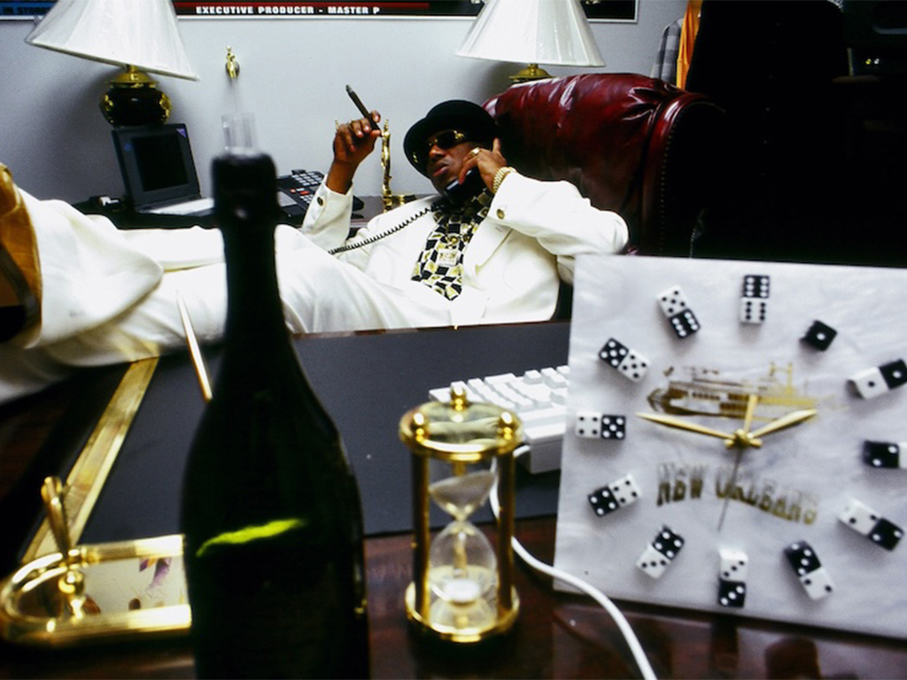 Photograph of Master P in his office on the phone making moves